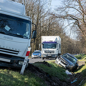 Truck and car accident scene on the roadside, representing Auto And Truck Accidents - Law Office of Ira Z. Miller