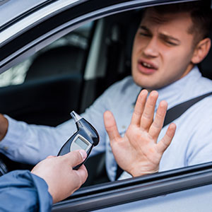 Driver refusing a breathalyzer test during a DWI stop by a police officer - Law Office of Ira Z. Miller